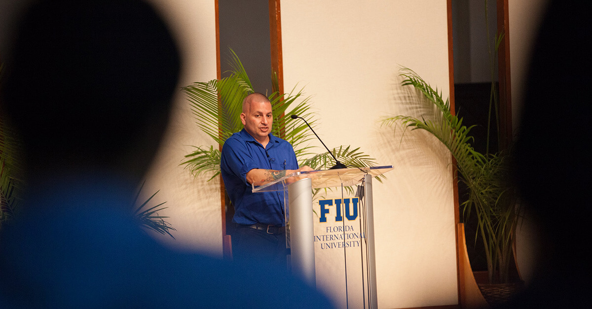 David Menasche speaking in front of crowd at FIU
